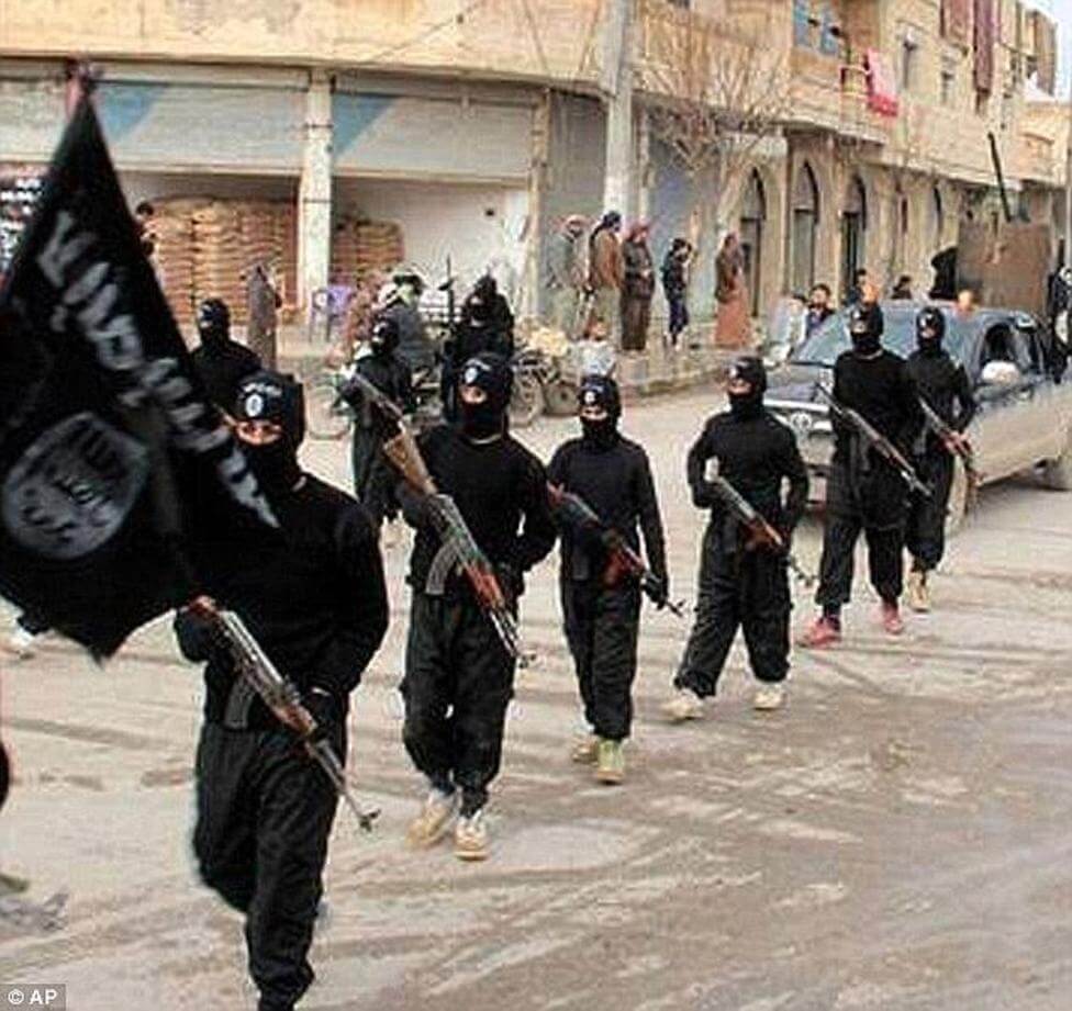 A group of masked militants in black uniforms marching with flags.
