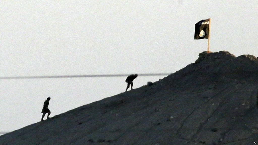 A person climbing a steep slope near a building.