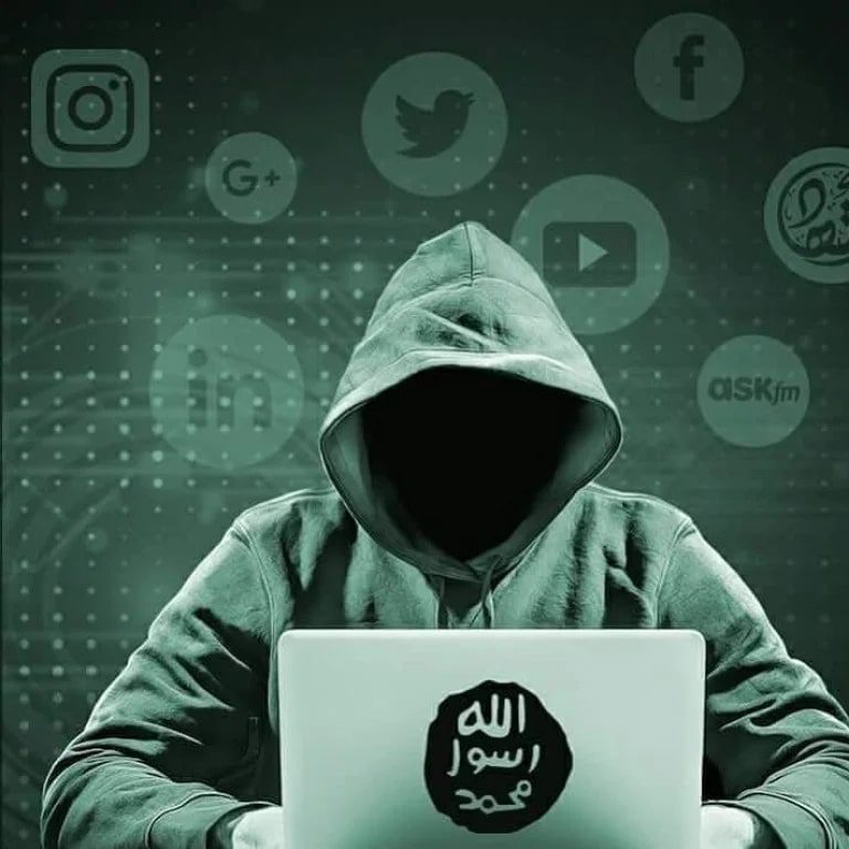 Hacker in a hoodie working on a laptop with a dark, ominous background.