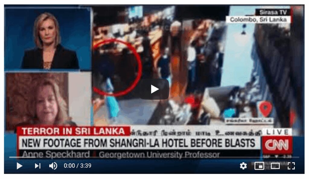 News footage showing a crowded scene at a hotel in Sri Lanka with a suspicious individual circled.