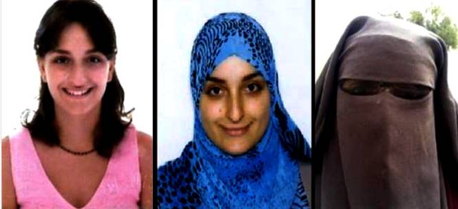 Portrait of a woman wearing a blue hijab with black patterns.