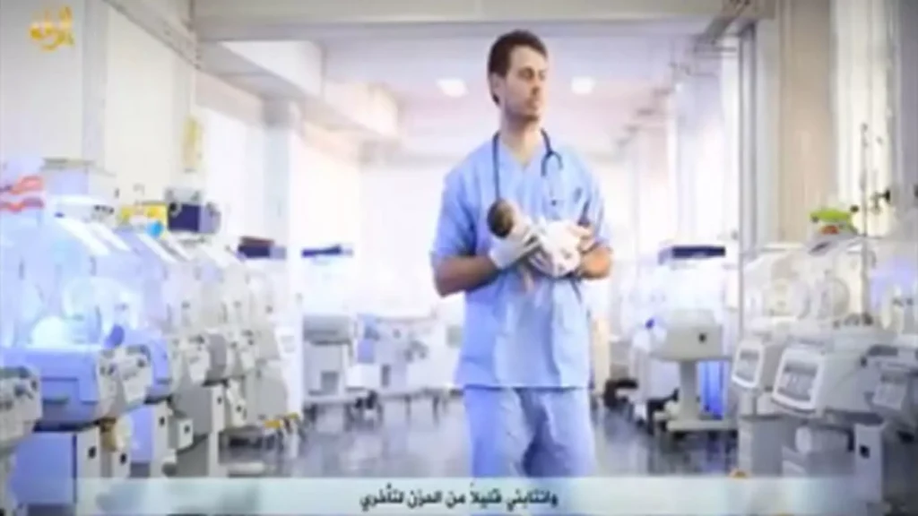 A healthcare professional holding a medical device in a hospital setting.