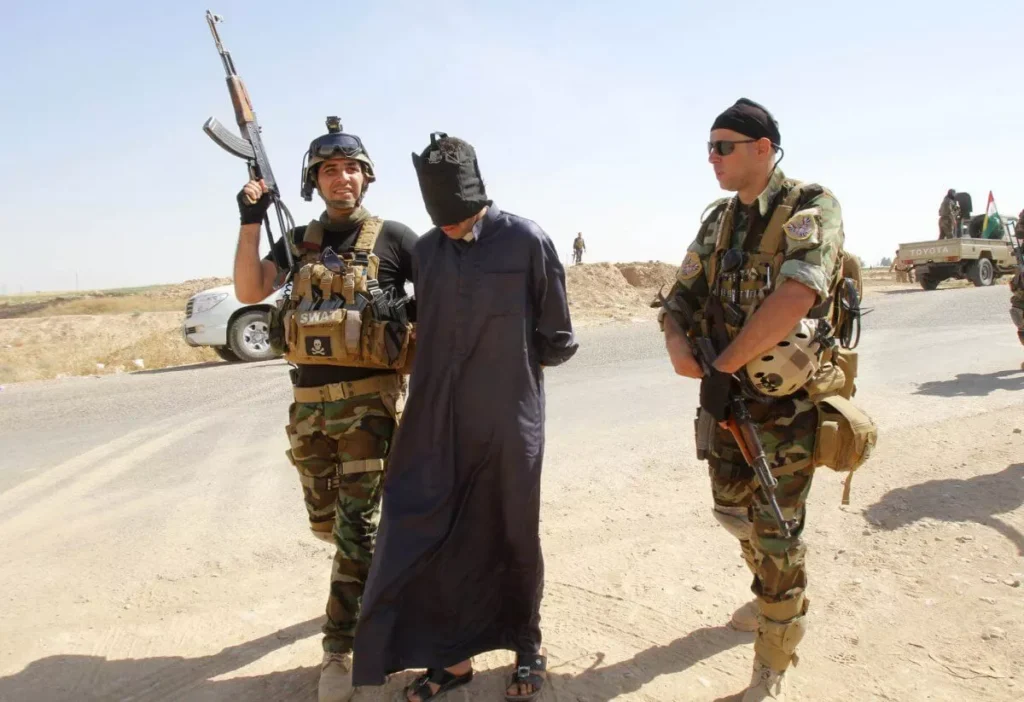 Armed soldiers flanking man with covered head