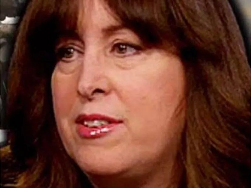 Close-up of a woman with brown hair and red lipstick.