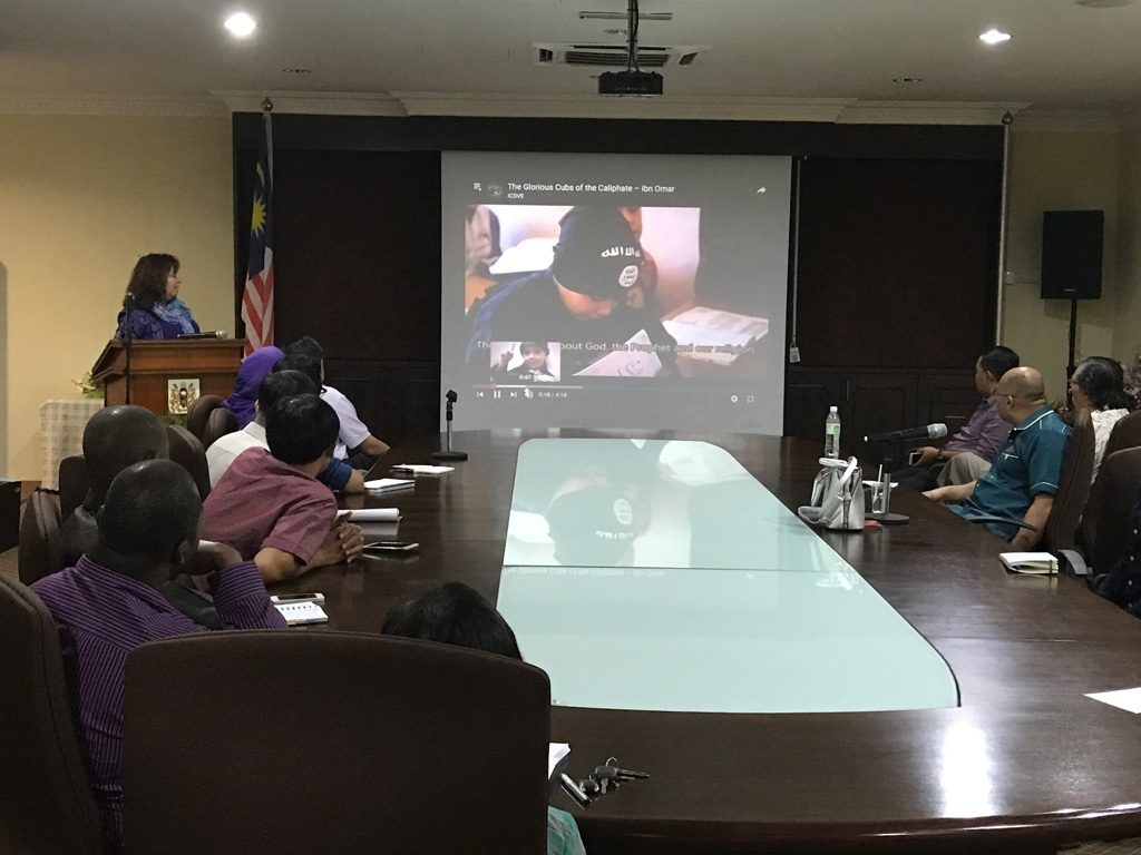 People attending a video conference in a meeting room.
