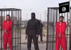 A masked person in black holding a gun between two people in red outfits behind cages.