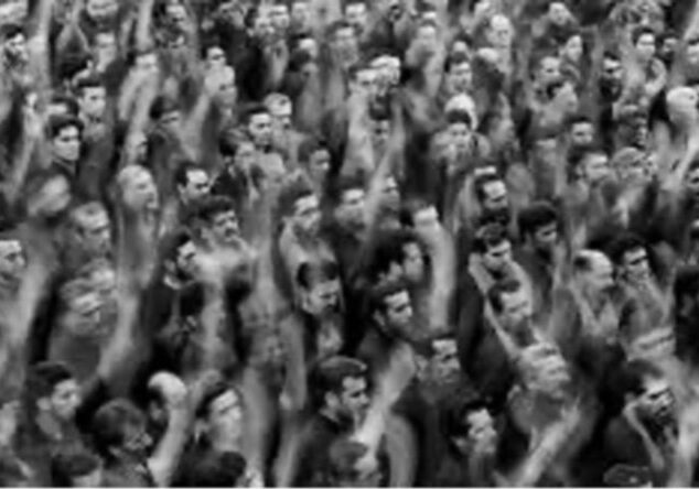 A crowd raising their fists, showing solidarity or protest.