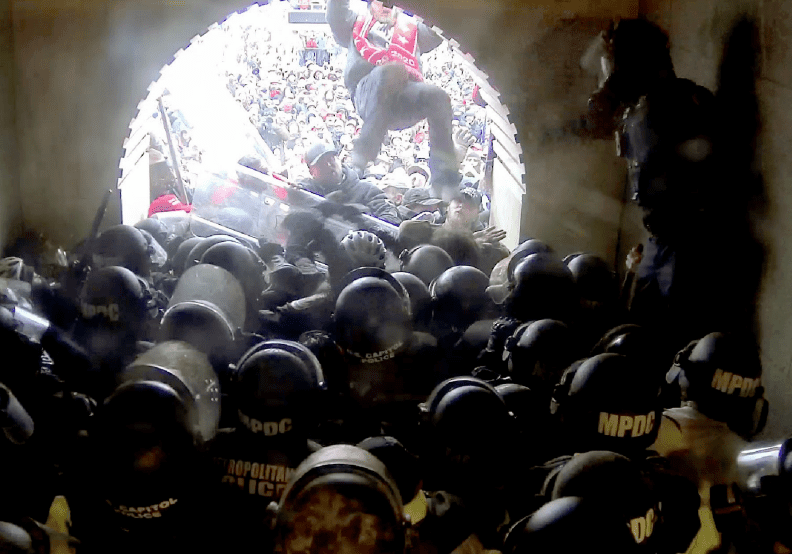 A chaotic clash between police and protesters in a confined tunnel.