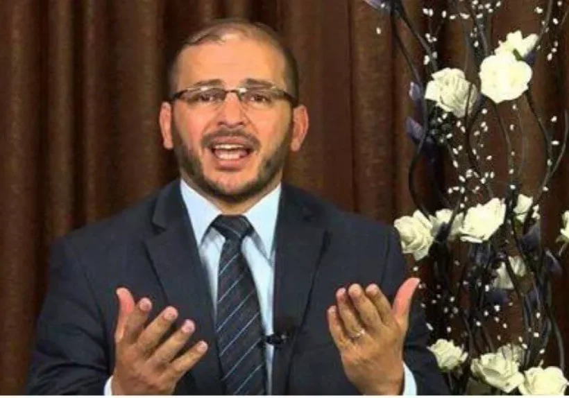 Man in suit gesturing while speaking